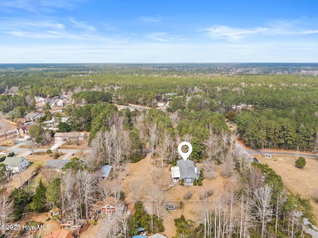 birds eye view of property with a view of trees