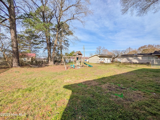 view of yard with a playground and fence