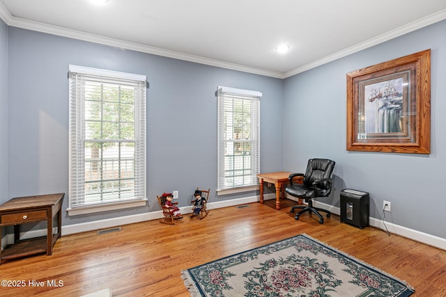 home office with baseboards, visible vents, ornamental molding, and wood finished floors