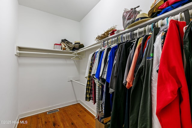spacious closet with visible vents and wood finished floors