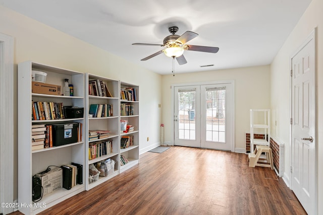 sitting room with french doors, a ceiling fan, visible vents, wood finished floors, and baseboards