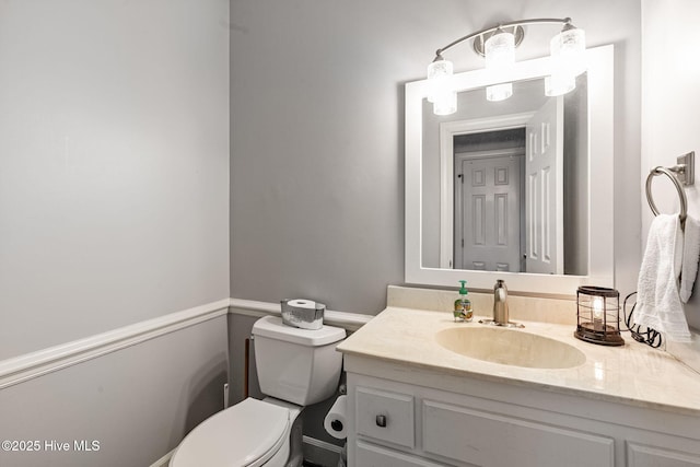bathroom featuring toilet and vanity