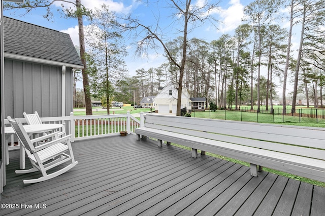 wooden terrace with fence and a lawn