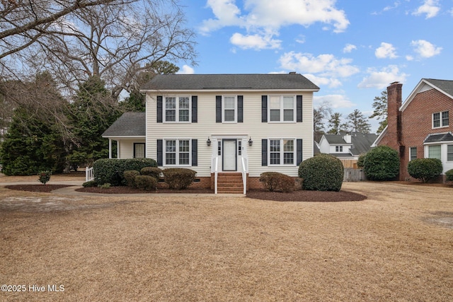 colonial-style house with crawl space and fence