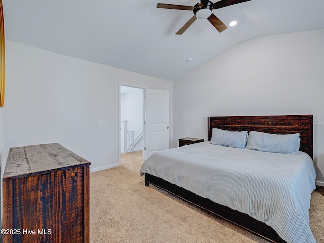 carpeted bedroom featuring lofted ceiling, ceiling fan, and baseboards