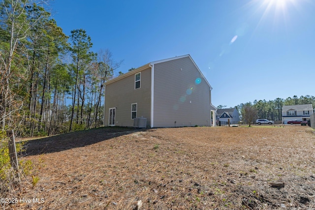 back of property featuring central AC