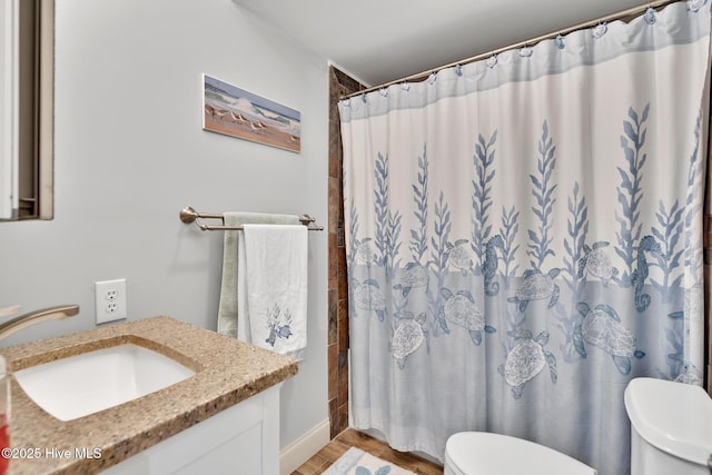 bathroom featuring wood finished floors, vanity, toilet, and a shower with curtain