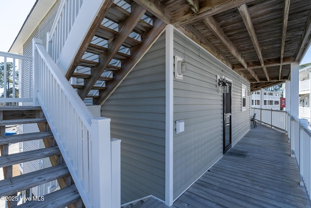 view of side of property featuring stairs