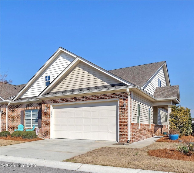 view of front of home featuring driveway, brick siding, an attached garage, and a shingled roof