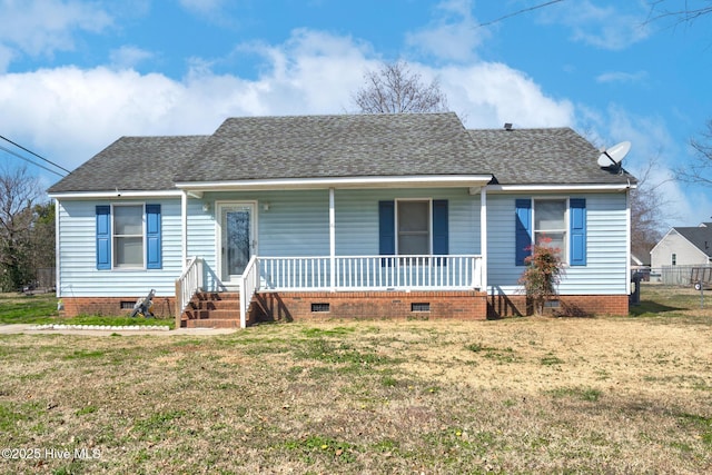 view of front facade featuring crawl space, covered porch, a shingled roof, and a front yard