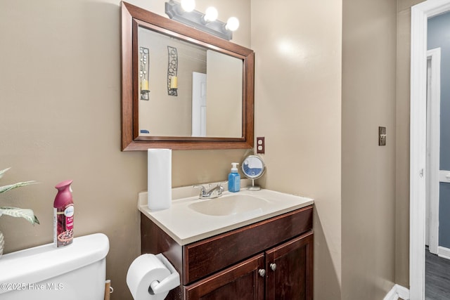 bathroom featuring vanity and toilet