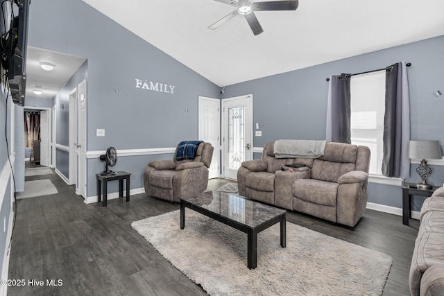 living room featuring dark wood-type flooring, lofted ceiling, baseboards, and a ceiling fan