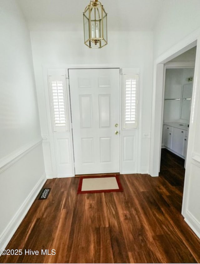 entrance foyer with visible vents and dark wood finished floors