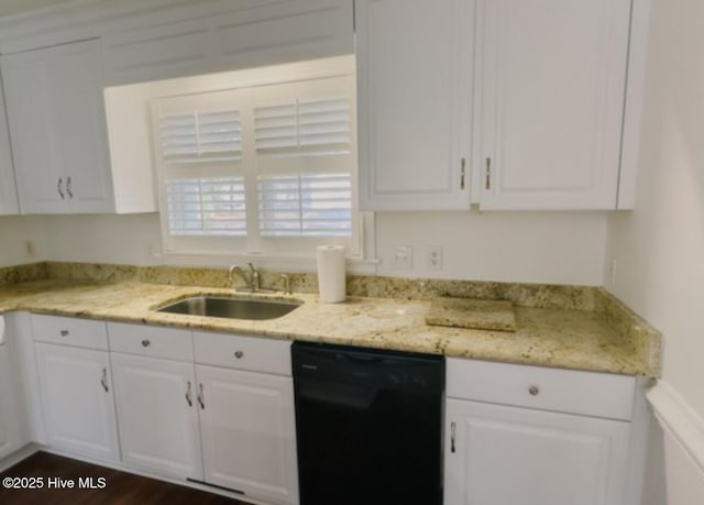 kitchen featuring light stone countertops, black dishwasher, white cabinetry, and a sink