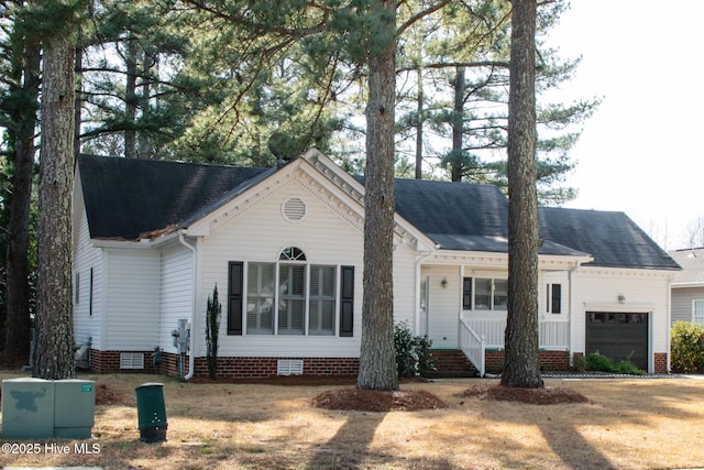 ranch-style house featuring a shingled roof, crawl space, and an attached garage