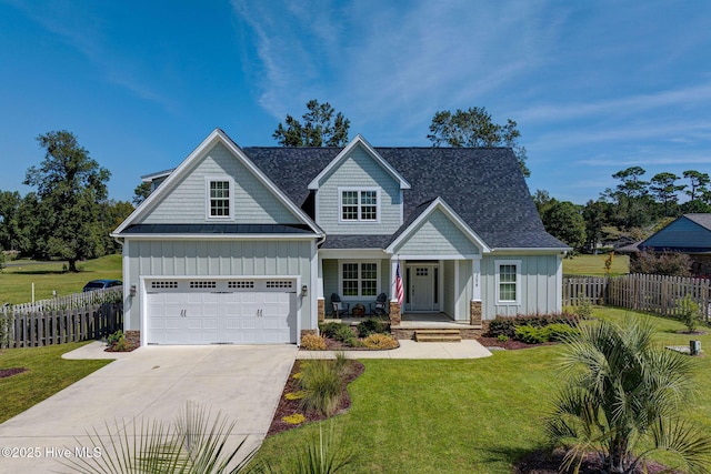 craftsman-style house with fence, driveway, roof with shingles, a front lawn, and board and batten siding