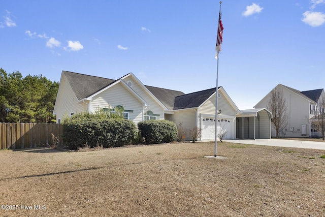 ranch-style home featuring an attached garage, fence, a front lawn, and concrete driveway