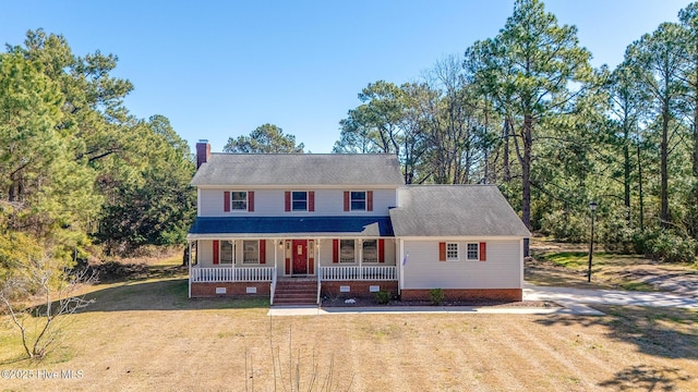 view of front facade featuring a front lawn, dirt driveway, a porch, a chimney, and crawl space