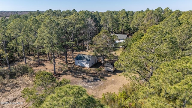 birds eye view of property with a forest view