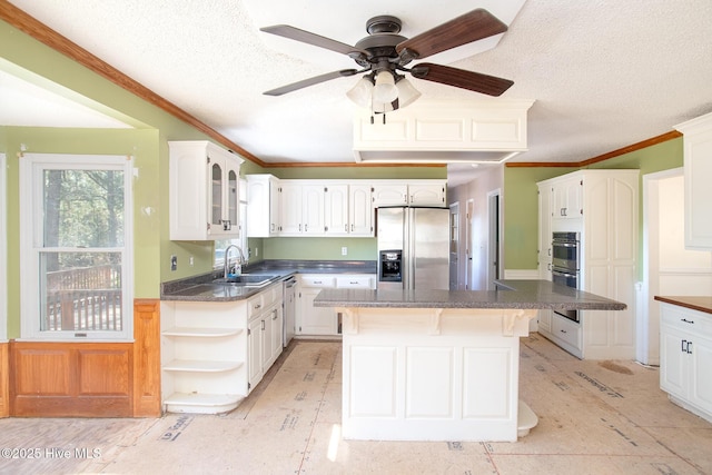 kitchen with a sink, open shelves, dark countertops, white cabinetry, and appliances with stainless steel finishes