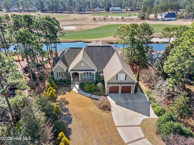 bird's eye view featuring view of golf course and a water view