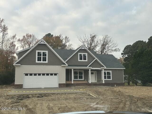 view of front of home featuring a garage and a porch