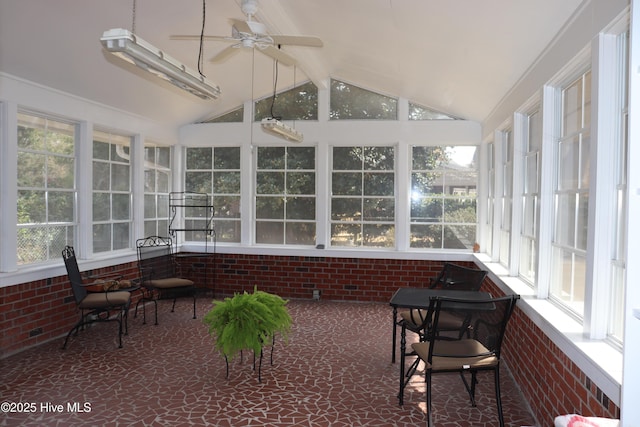 sunroom featuring lofted ceiling with beams and a ceiling fan