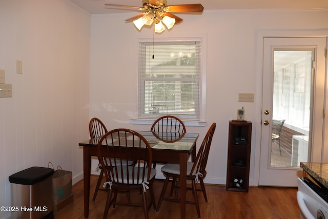 dining room featuring crown molding, ceiling fan, and dark wood-style flooring