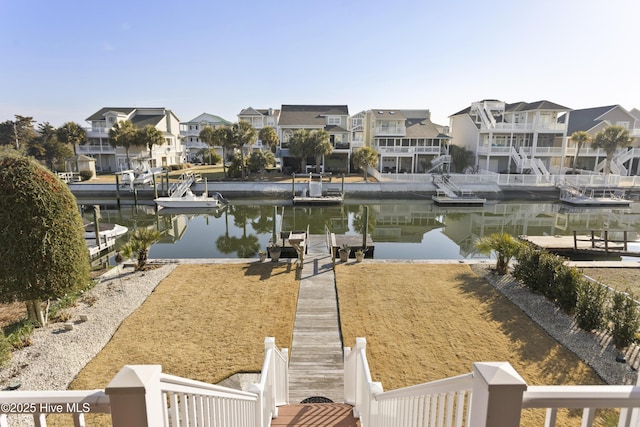 view of dock featuring a residential view and a water view