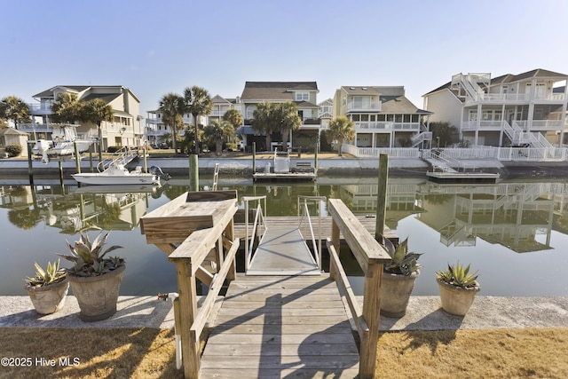 view of dock featuring a water view and a residential view