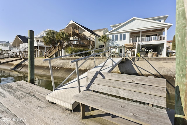 view of dock with stairs and a residential view