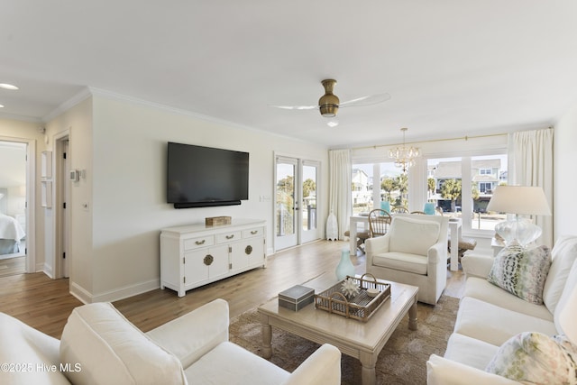 living room featuring ornamental molding, french doors, plenty of natural light, and wood finished floors