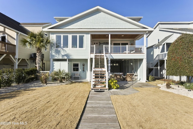 back of property featuring a patio area and stairway