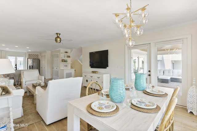 dining area with light wood-style floors, recessed lighting, crown molding, and ceiling fan with notable chandelier