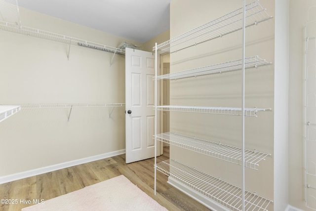 spacious closet with wood finished floors