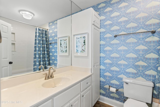 full bath with a shower with shower curtain, toilet, vanity, baseboards, and wallpapered walls