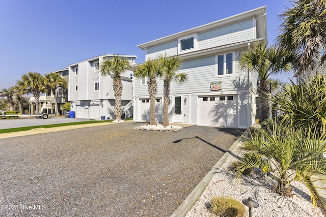 beach home with a garage and driveway