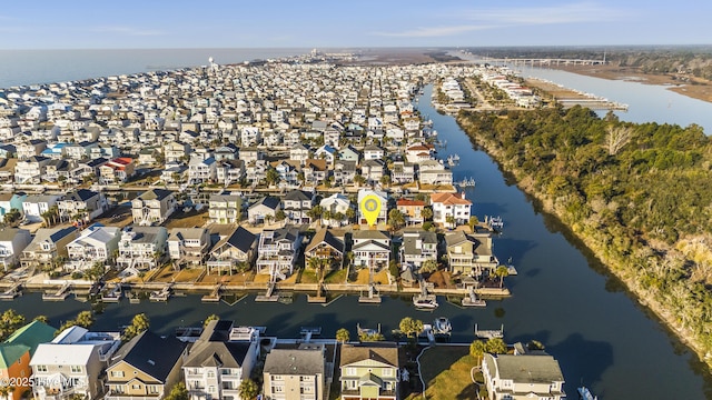 drone / aerial view with a water view and a residential view