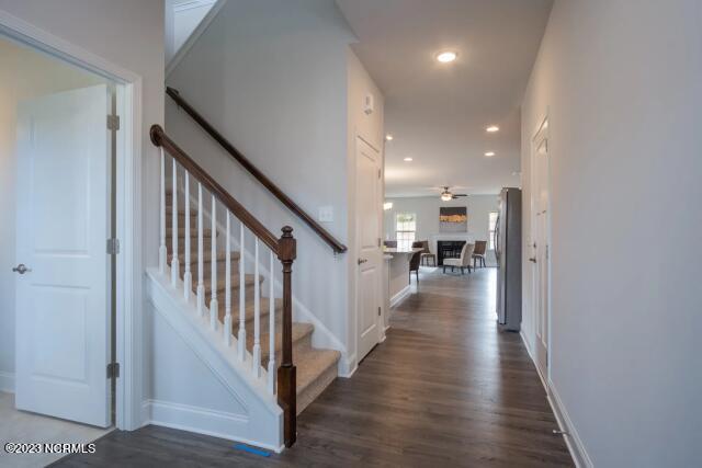 staircase with baseboards and wood finished floors