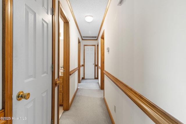 hall featuring ornamental molding, light colored carpet, and visible vents