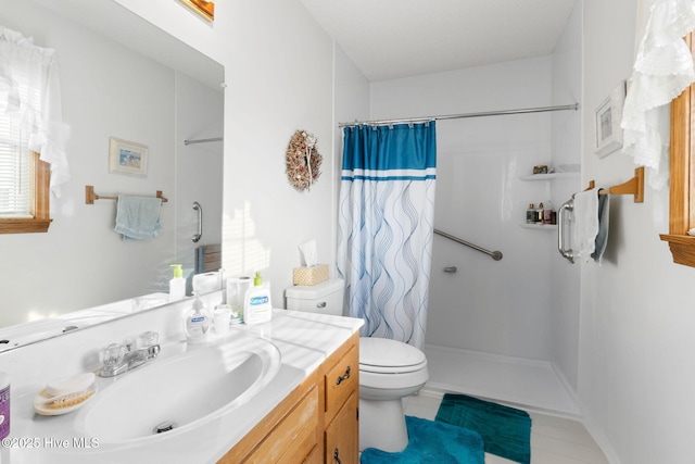 full bathroom with a shower stall, toilet, and vanity