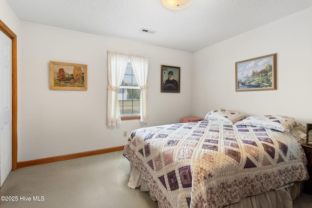 carpeted bedroom with a textured ceiling, visible vents, and baseboards