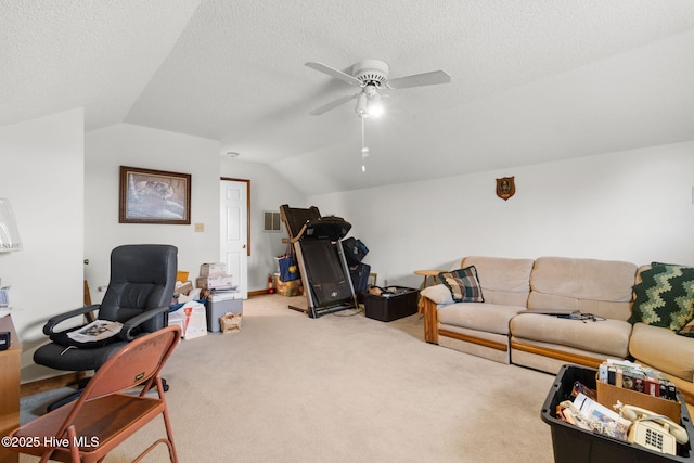 living area with lofted ceiling, light carpet, ceiling fan, and a textured ceiling