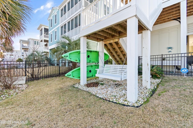 view of property's community featuring a yard and fence