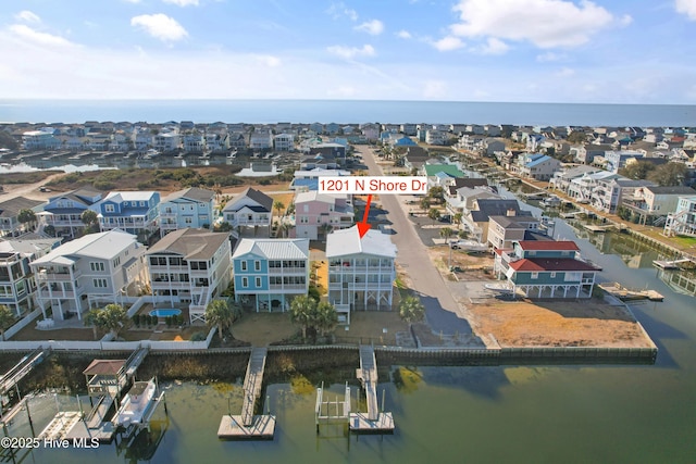 birds eye view of property with a residential view and a water view