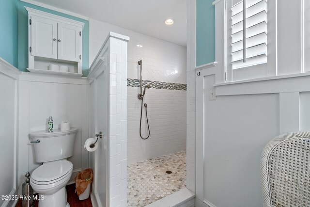 bathroom featuring recessed lighting, toilet, and walk in shower