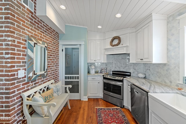 kitchen featuring white cabinetry, wooden ceiling, backsplash, and appliances with stainless steel finishes