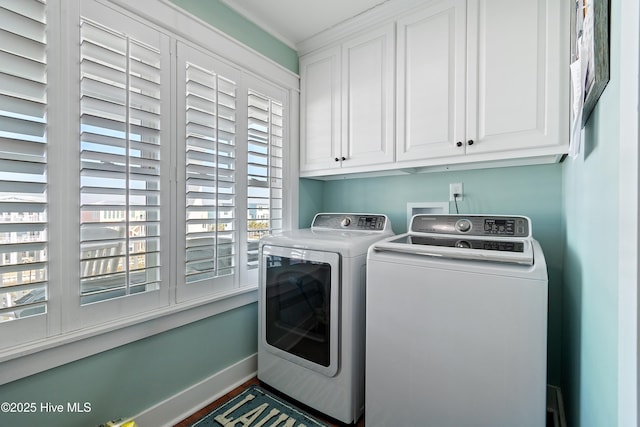 laundry room featuring washer and clothes dryer, cabinet space, and baseboards