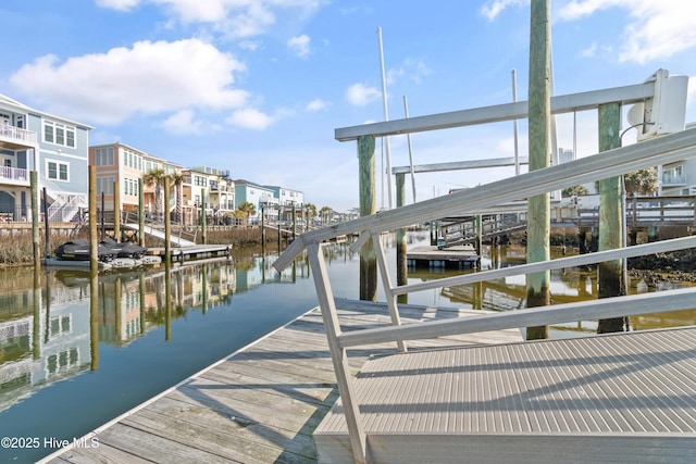 view of dock with a residential view and a water view