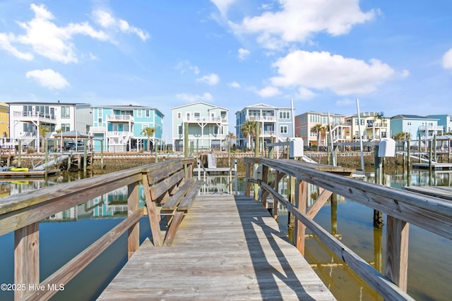 view of dock featuring a residential view and a water view